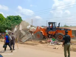Caterpillar demolishing structures at Karmo market in Abuja on Wednesday