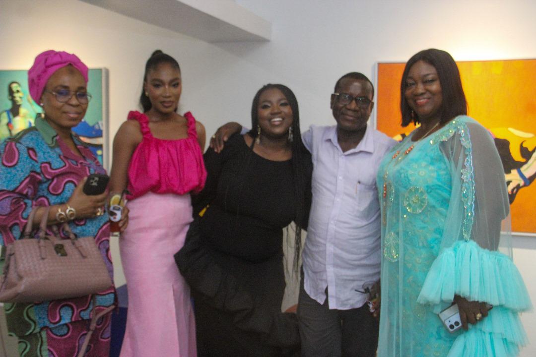 Tomike Layi-Babatunde flanked by her parents and guests