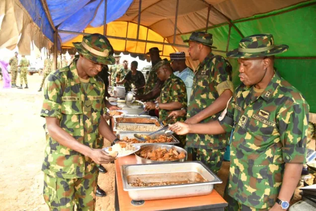 From the right the GOC serving food to troops of Operation Whirl Punch during Chief of Army Staff Sallah Luncheon in Birnin Gawri Local Government Area on Sunday.