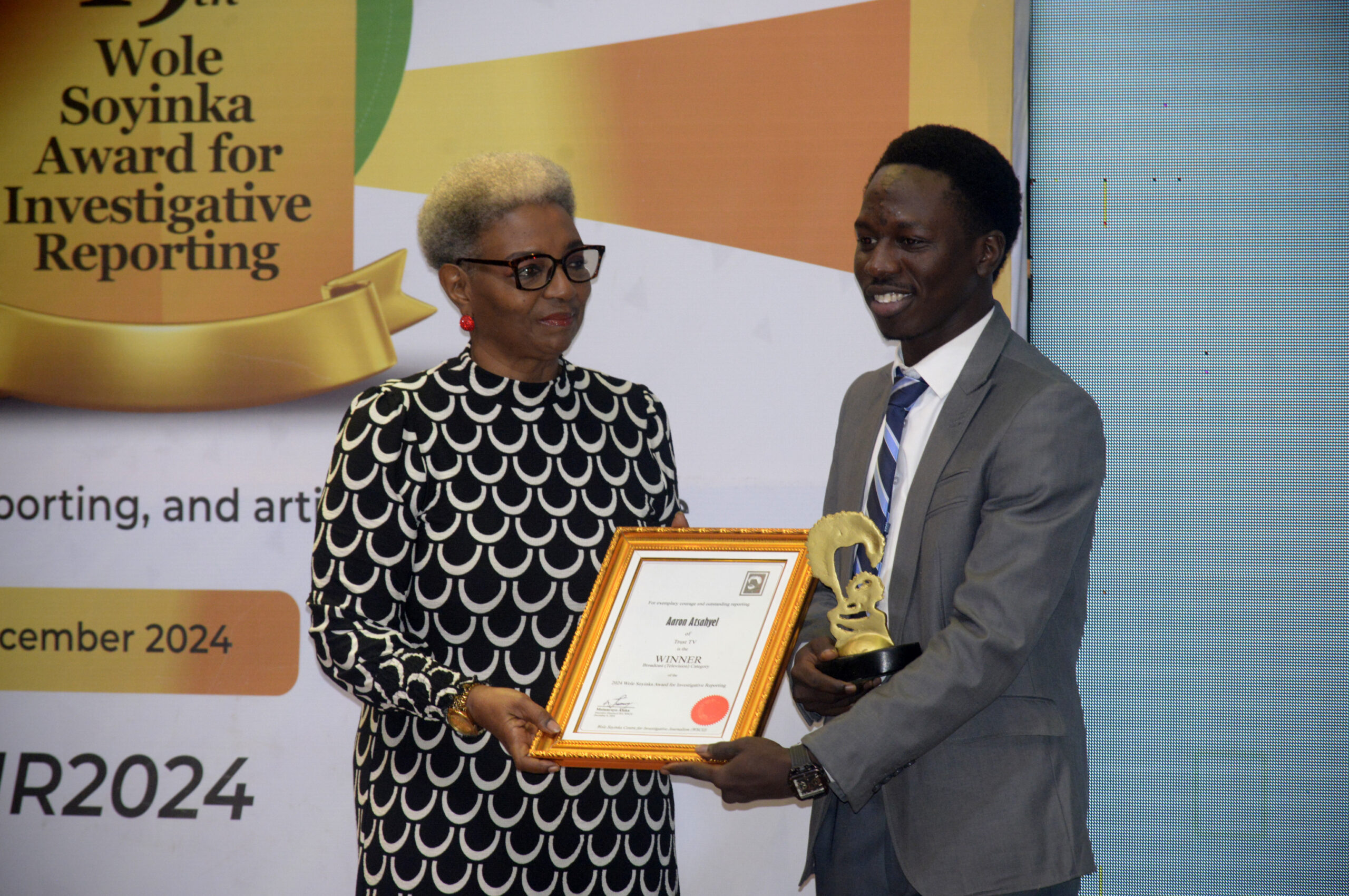 Aaron Atsahyel of Trust TV/winner of TV Category (right), receives his award from Bimbo Oloyede, veteran broadcaster, during the 19th Wole Soyinka Award for Investigative Reporting held at the AGIP Recital Hall of the MUSON Centre in Lagos, on Monday, December 9, 2024.