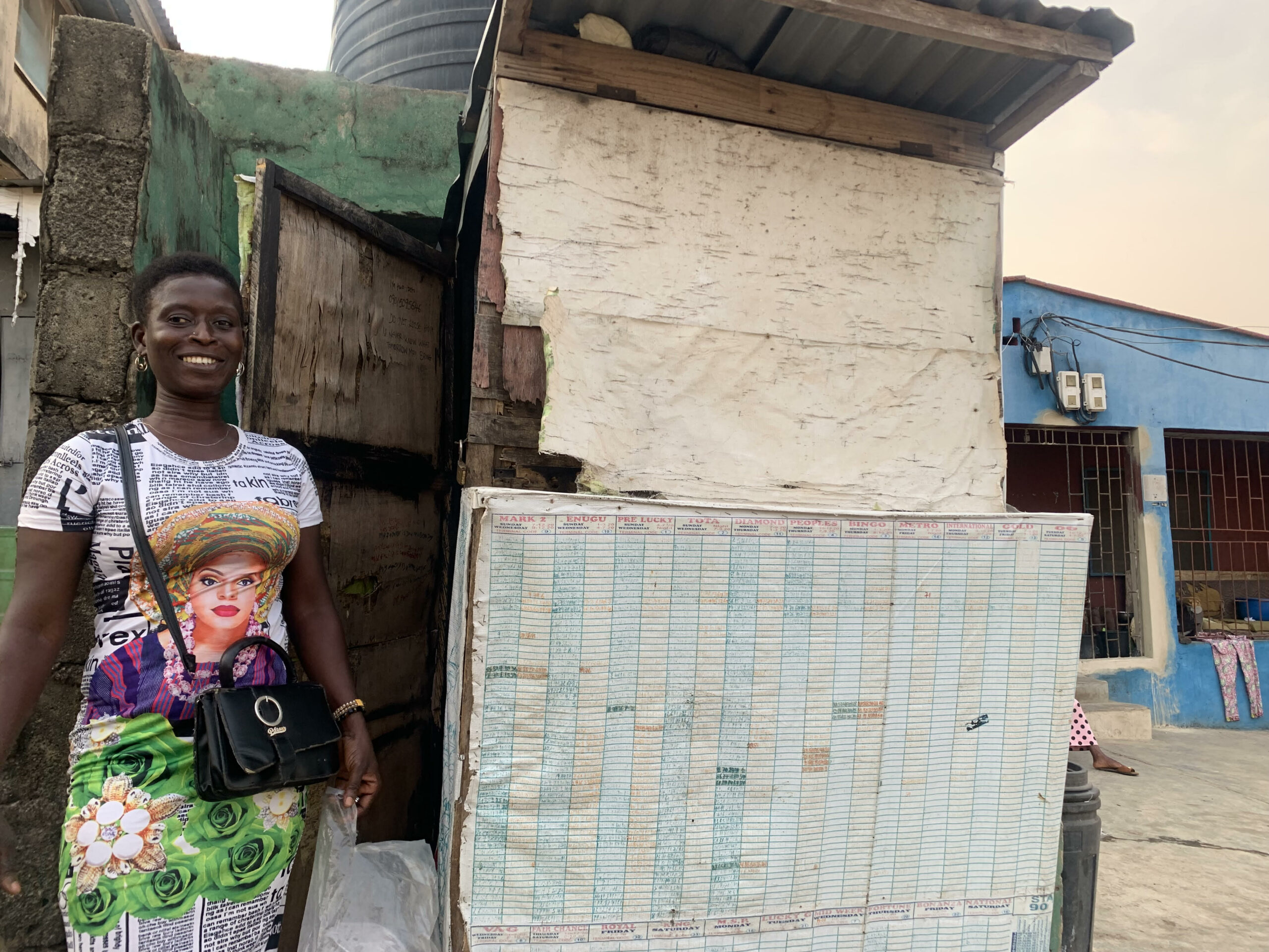 Iya Ibeji Lotto next to her kiosk. Credit: Simbiat Bakare
