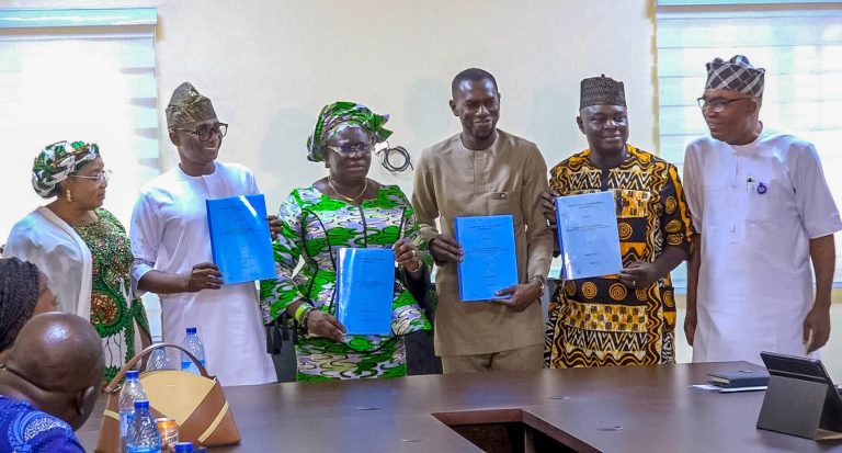 The Kogi SGS, Dr Folashade Ayoade (3L); Kogi Commissioner for Information and Communication, Mr Femi Fanwo (2L); Team Lead of Pora Films, Mr Olajide Ofonufi, during after signing of MoU to establish Kogi TV, on Friday in Lokoja MoU