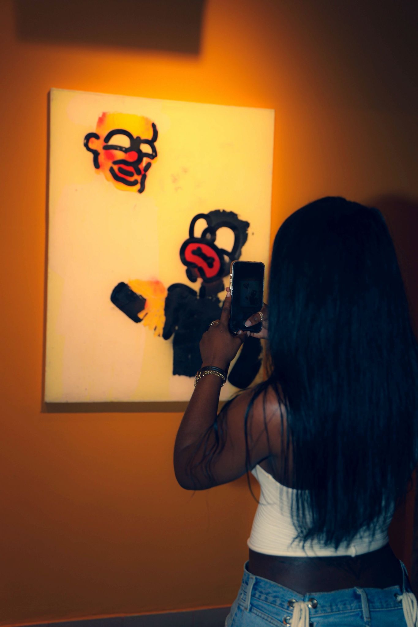 A guest taking a picture of one of the art pieces.