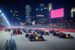 Formula 1 cars race through a city street
