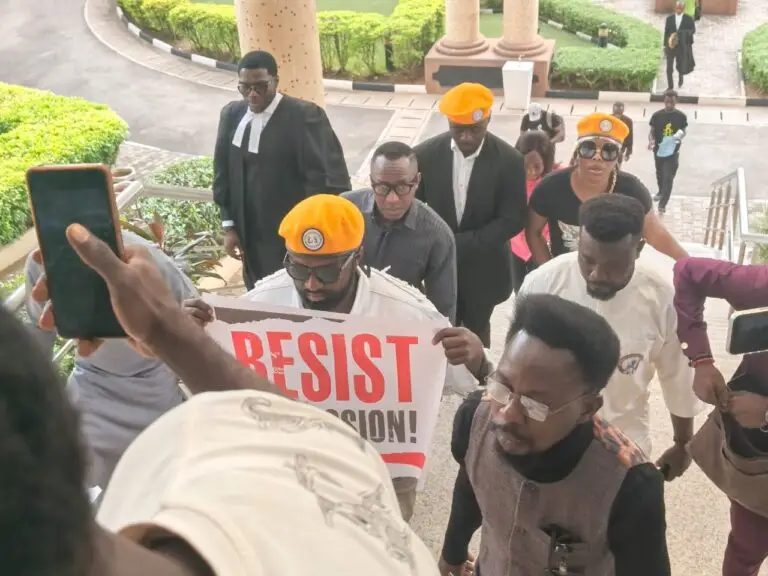 Omoyele Sowore (at the middle) being accompanied by members of his group into the Federal High Court in Abuja on