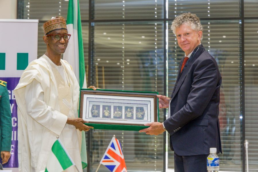 NSA, Mallam Nuhu Ribadu (Left), presenting a souvenir to his counterpart from the UK, Jonathan Powell