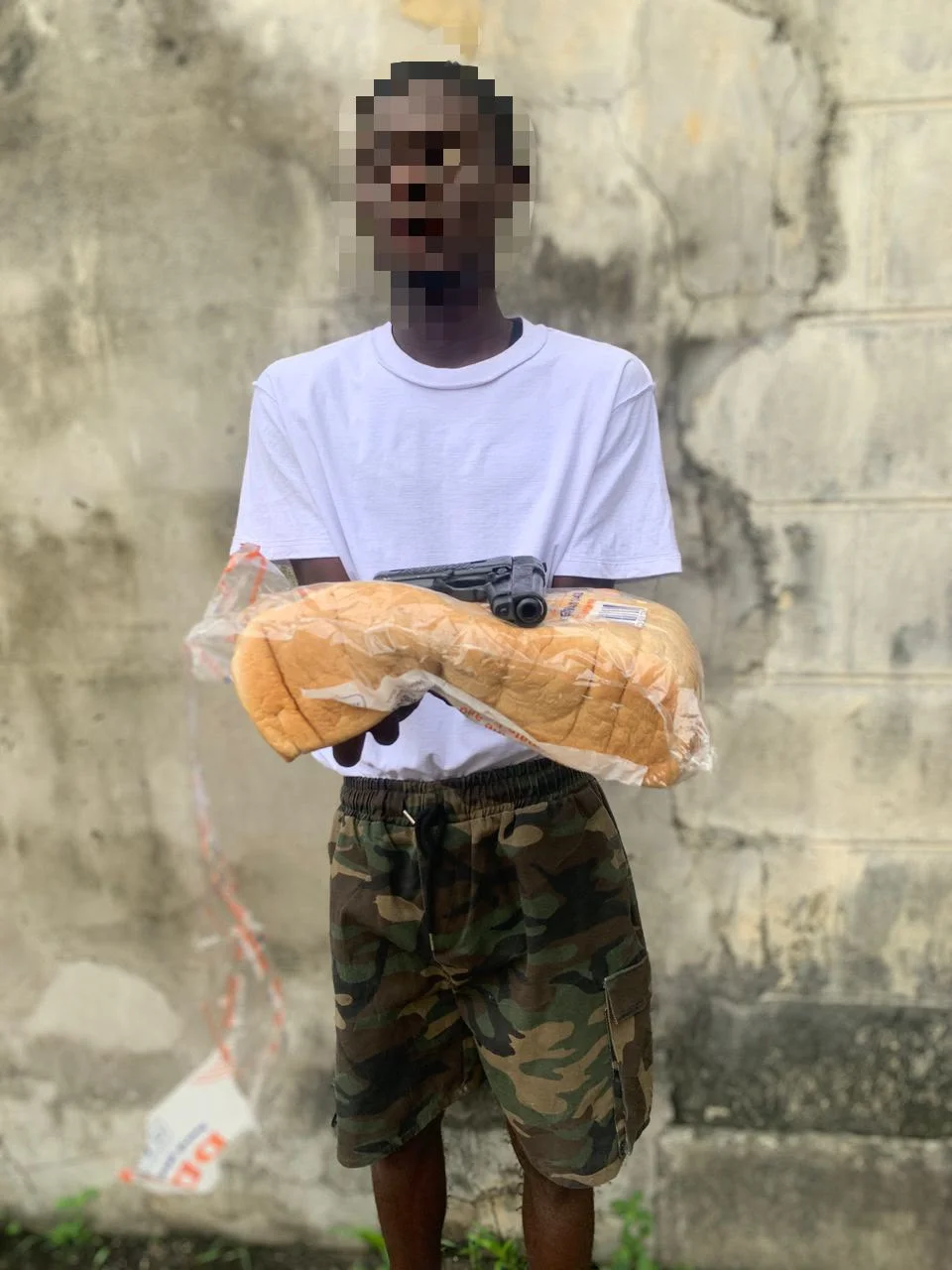 Police operatives recover pistol hidden in a loaf of bread by a vehicle passenger identified as Braya Nanas in Port Harcourt, Rivers State