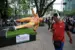 A passer-by walks past a giant sculpture, part of the urban exhibition "Gigantes del Futbol" (Giants of football) which was pulled down during a protest by the National Coordination of Education Workers (CNTE) calling for a general strike and protests around stadiums hosting World Cup matches, ahead of the upcoming FIFA 2026 World Cup, in Mexico City, on June 2, 2026. (Photo by CARL DE SOUZA / AFP)